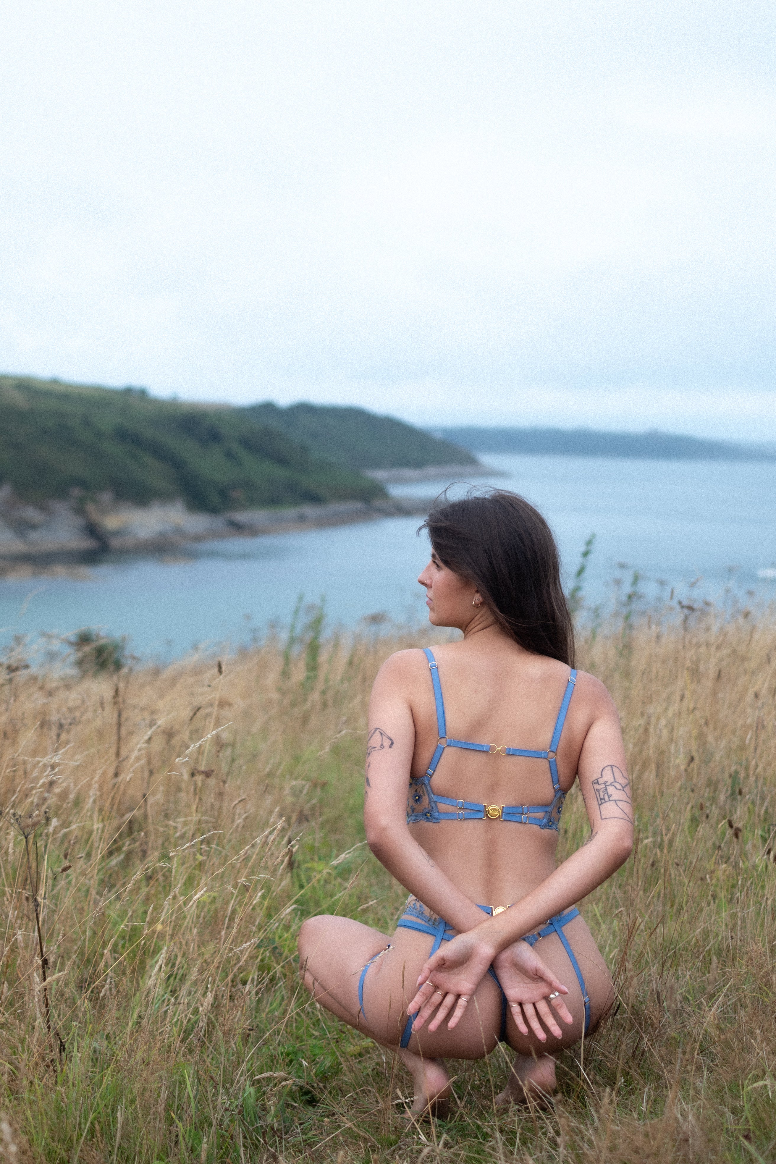 Model showing the back of the blue longline bra.